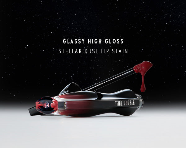 TimePhoria STELLAR DUST LIP STAIN Glassy high-gloss stellar dust lip stain with applicator on a black background
