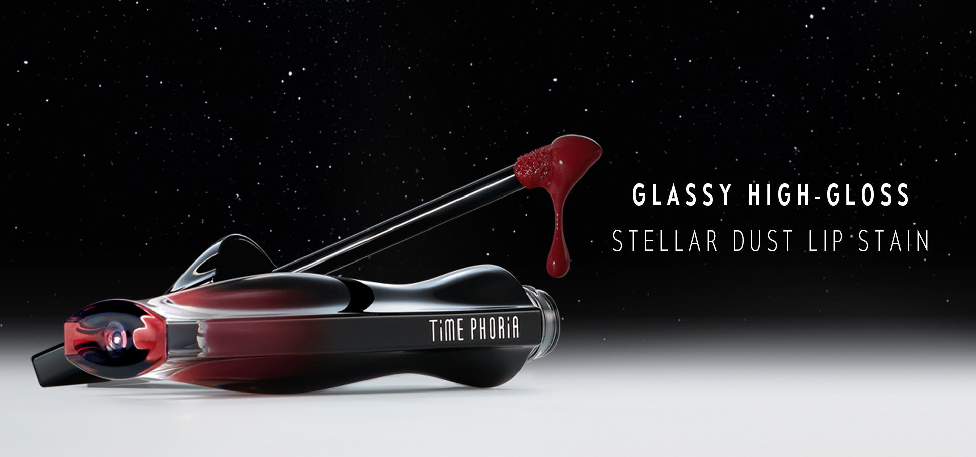 Glassy high-gloss stellar dust lip stain with 'Time Phora' branding on a dark background